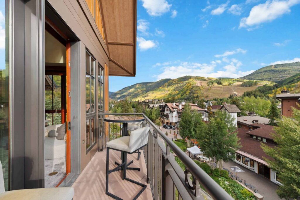 barstool and table on a balcony of a mountain lodge