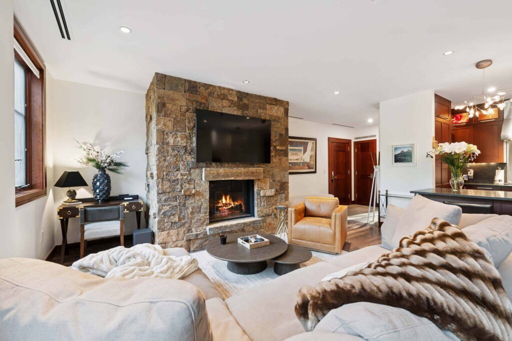living room with a fireplace, TV, and two couches
