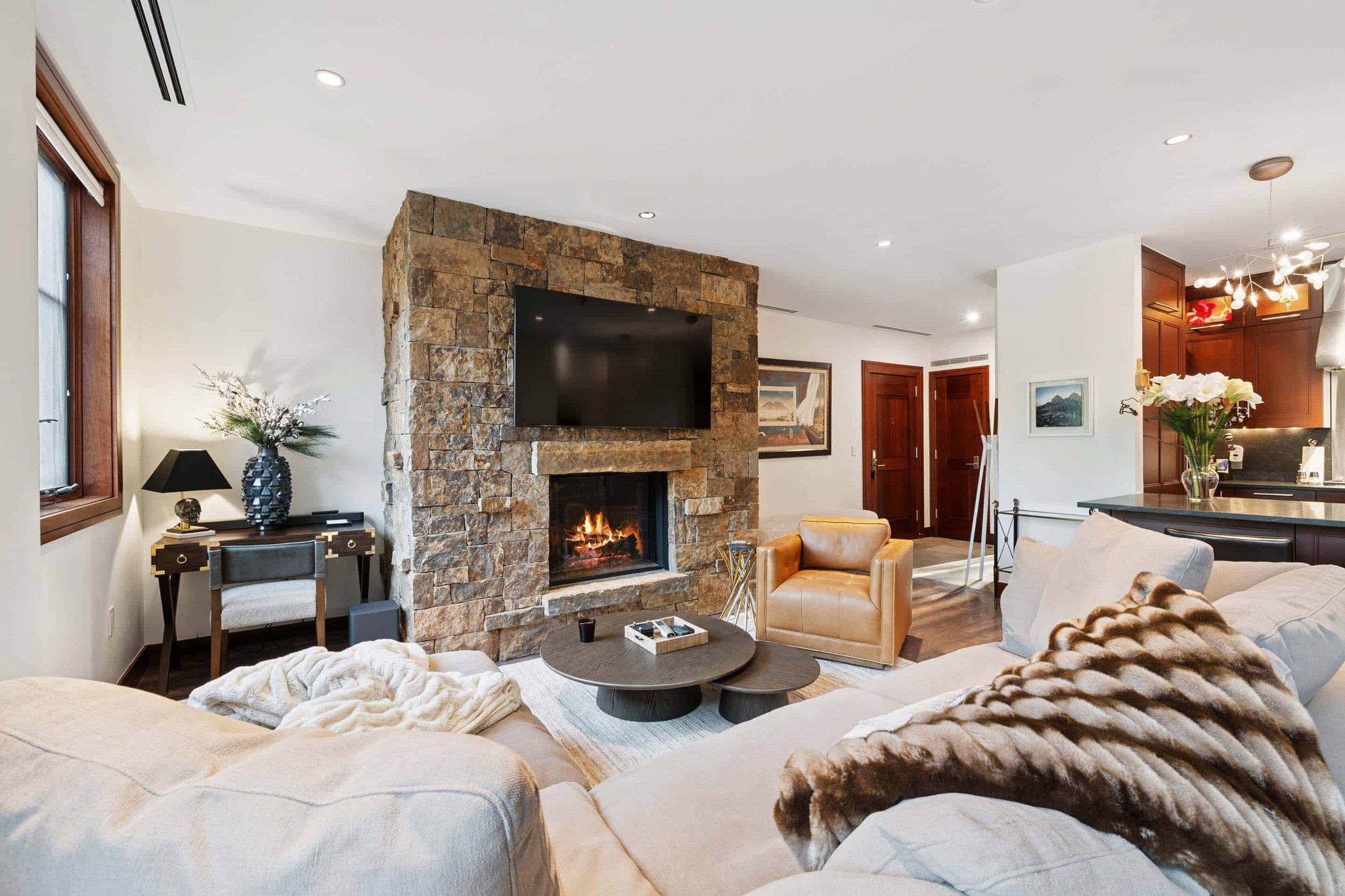 living room with a fireplace, TV, and two couches