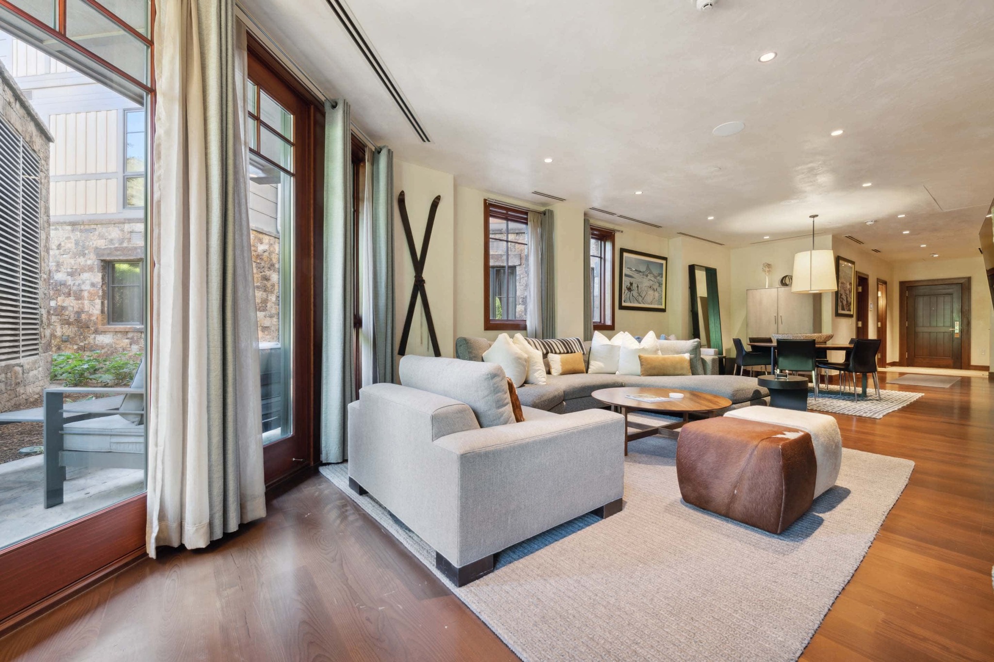 living room in a ski lodge with skiis on the wall